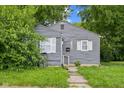 Charming home featuring grey siding, white shutters, and a well-kept lawn at 2359 N Gale St, Indianapolis, IN 46218