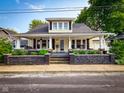 Classic home featuring a covered porch with charming details and well-maintained landscaping at 251 North St, Danville, IN 46122