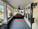 Relaxing front porch with swing, ceiling fan, and a view of the neighborhood at 251 North St, Danville, IN 46122