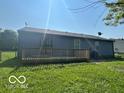 View of home's back wooden deck and grassy backyard, with privacy fence at 2930 N Rural St, Indianapolis, IN 46218