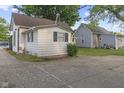 The side of a charming two-story home with a long concrete driveway at 330 S Green St, Brownsburg, IN 46112