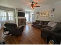 Cozy living room with hardwood floors, a brick fireplace, and comfortable seating at 4740 Milton St, Coatesville, IN 46121