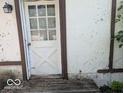 Exterior view of weathered back door with glass inserts and peeling paint at 489 W Sumner Ave, Martinsville, IN 46151