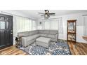 Inviting living room with a comfortable sectional, modern lighting, and stylish decor at 504 Broadway Ave, Arcadia, IN 46030