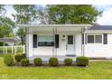 Charming front porch with manicured landscaping, enhancing curb appeal and providing a welcoming entrance at 533 Patterson Rd, Columbus, IN 47203