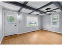 Bright living room features wood-look flooring, custom ceiling beams, and fresh light blue paint at 533 Patterson Rd, Columbus, IN 47203
