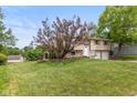 Two-story home features a well maintained yard and driveway leading to the attached garage at 5802 Rymark Ct, Indianapolis, IN 46250