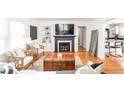 Bright and inviting living room featuring a fireplace, built-in shelves, and hardwood floors at 6045 Crittenden Ave, Indianapolis, IN 46220