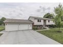 Home with a two-car garage, wide driveway, and well-maintained landscaping surrounding the property at 617 Echo Bend Blvd, Greenwood, IN 46142
