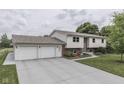 Spacious home with a two-car garage and expansive driveway, set against a lush, green landscape at 617 Echo Bend Blvd, Greenwood, IN 46142