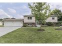 Inviting home featuring a neatly kept lawn, beautiful landscaping, and a convenient two-car garage at 617 Echo Bend Blvd, Greenwood, IN 46142