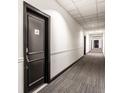 Hallway featuring neutral walls, carpeted floors and multiple apartment doors, creating a clean and modern aesthetic at 624 E Walnut St # 48, Indianapolis, IN 46204