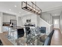 Contemporary open-concept kitchen and dining area with stainless steel appliances and modern lighting at 6659 Halsey St, Zionsville, IN 46077