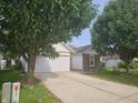 Charming exterior view of a home with a two-car garage and a long driveway at 7307 Barnwell Pl, Indianapolis, IN 46217