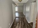 Inviting hallway with modern wood flooring, neutral paint, and an open view into the living area at 7307 Barnwell Pl, Indianapolis, IN 46217