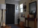 Inviting entryway featuring a dark door and stylish decorations on a console table at 7357 Lake Lakota Dr, Indianapolis, IN 46217