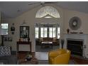 Inviting living room with vaulted ceiling, fireplace, and an open layout into another seating area at 7357 Lake Lakota Dr, Indianapolis, IN 46217