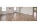 Bright living room boasts gorgeous wood floors, neutral walls, and plentiful natural light at 7510 Hillway Dr, Camby, IN 46113