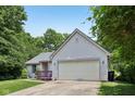 Beautiful single-story home with an attached garage and well-manicured lawn at 7831 Bayridge Dr, Indianapolis, IN 46236