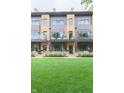 Modern townhome showcasing a well-maintained lawn, front patio, and contemporary design at 80 Monon Blvd, Carmel, IN 46032