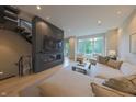 Stylish living room featuring a modern fireplace, staircase, and abundant natural light at 80 Monon Blvd, Carmel, IN 46032