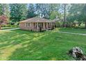 Beautiful ranch home with a large grassy lawn and mature shade trees at 802 Lawrence Ave, Indianapolis, IN 46227