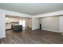 Spacious open-concept living room and kitchen, featuring modern flooring and neutral paint at 802 Lawrence Ave, Indianapolis, IN 46227
