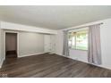 Bright living room with large windows, neutral walls, and modern flooring at 802 Lawrence Ave, Indianapolis, IN 46227