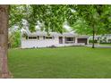 Lovely single-story home with brick accents, a lush green lawn, and a convenient attached two-car garage at 8115 Englewood Rd, Indianapolis, IN 46240