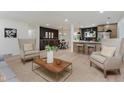 Bright living room with stylish furnishings, hardwood floors, and an open layout to the kitchen and dining area at 8115 Englewood Rd, Indianapolis, IN 46240