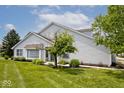 Well-maintained home featuring lush landscaping, healthy lawn, and a charming exterior at 8247 Cape N Dr, Indianapolis, IN 46256