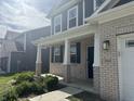 Inviting front porch with white columns, brick accents, and a dark-colored front door at 8969 Faulkner Dr, Indianapolis, IN 46239