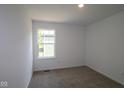 Well-lit bedroom with carpet floors and a single window at 9516 Bauhaus Way, Indianapolis, IN 46240