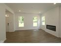 Bright living room featuring hardwood floors and a modern fireplace at 9516 Bauhaus Way, Indianapolis, IN 46240