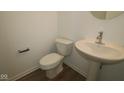 Cozy powder room featuring neutral walls and a pedestal sink at 9516 Bauhaus Way, Indianapolis, IN 46240