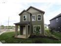 Beautiful exterior of a two-story home featuring green siding and a well-maintained lawn at 9520 Bauhaus Way, Indianapolis, IN 46240