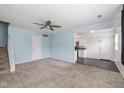 Open living space with carpet and views of the kitchen featuring updated appliances at 10016 Penrith Dr, Indianapolis, IN 46229