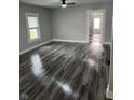 Open living room with gray wood flooring, gray paint, and modern ceiling fan, offering a comfortable living space at 1006 Hurricane St, Franklin, IN 46131