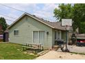 Back of home with green siding, a sliding glass door, a patio, and a basketball hoop at 103 Bentwood Dr, Greenwood, IN 46143