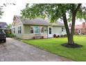 Charming single-story home with green siding, manicured lawn, and an asphalt driveway at 103 Bentwood Dr, Greenwood, IN 46143