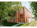 Beautifully designed home with unique exterior featuring an inviting entrance and a well-kept front lawn with sidewalk at 1210 Churchman Ave, Indianapolis, IN 46203