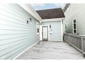 A spacious back porch of a light-blue home with a door that leads inside at 1221 Cottage Ave, Indianapolis, IN 46203