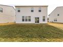 The backyard has a small patio area with a grassy lawn that stretches to the property line at 1381 Delacorte Cir, Shelbyville, IN 46176