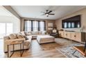 Cozy living room featuring a plush sectional sofa, a ceiling fan, and wood flooring at 1381 Delacorte Cir, Shelbyville, IN 46176