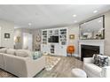 Cozy living room with built-in shelving, a fireplace, and comfortable seating area at 14442 Treasure Creek Ln, Fishers, IN 46038