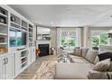 Bright living room featuring a fireplace, built-in shelving, and stylish furniture at 14442 Treasure Creek Ln, Fishers, IN 46038