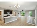 A modern kitchen with stainless steel appliances, dark cabinetry, light countertops, and wood flooring at 14474 Treasure Creek Ln, Fishers, IN 46038