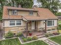 Beautiful house with stone details, inviting porch, and a well-kept landscaped front yard at 1532 E Markwood Ave, Indianapolis, IN 46227