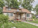Charming home featuring stone accents, a covered porch, and meticulously landscaped front yard at 1532 E Markwood Ave, Indianapolis, IN 46227