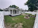 Large fenced backyard with fire pit, garden boxes, and well-maintained landscaping at 1556 N Euclid Ave, Indianapolis, IN 46201